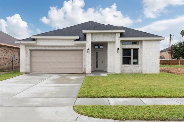 prairie-style home with a garage and a front lawn