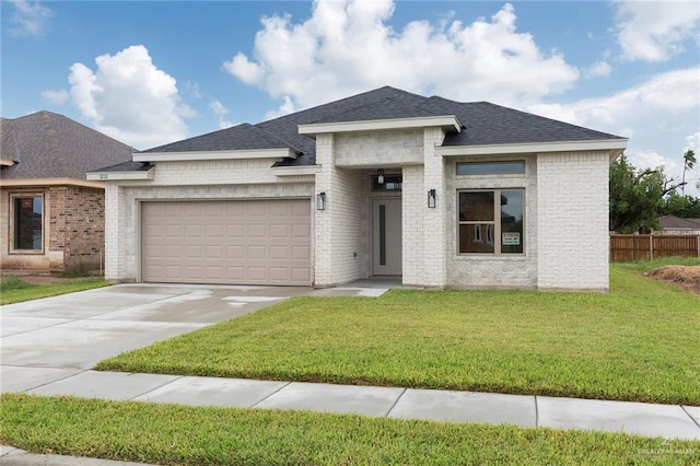 prairie-style house with a front yard and a garage