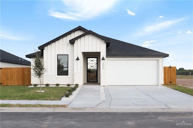 modern farmhouse style home featuring a garage and a front yard