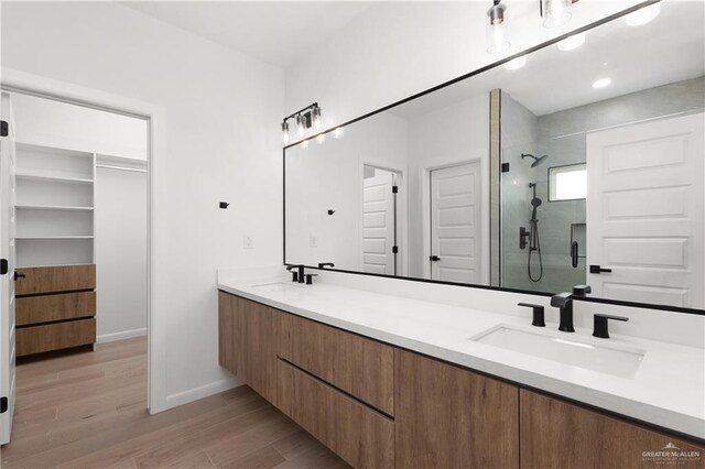 bathroom with vanity, an enclosed shower, and hardwood / wood-style flooring