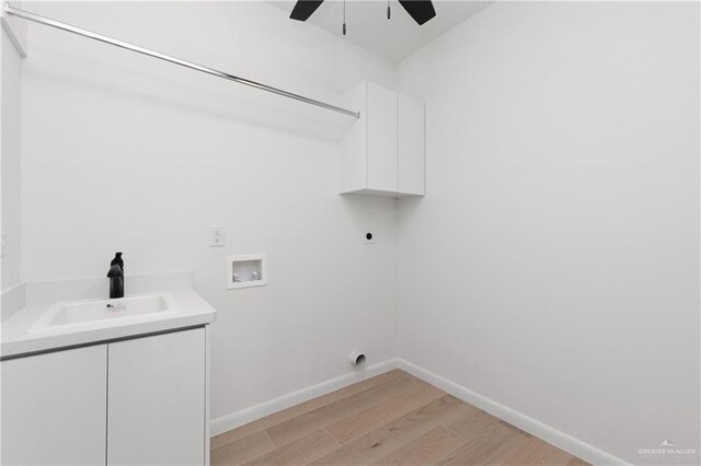 washroom featuring sink, cabinets, washer hookup, electric dryer hookup, and light hardwood / wood-style flooring