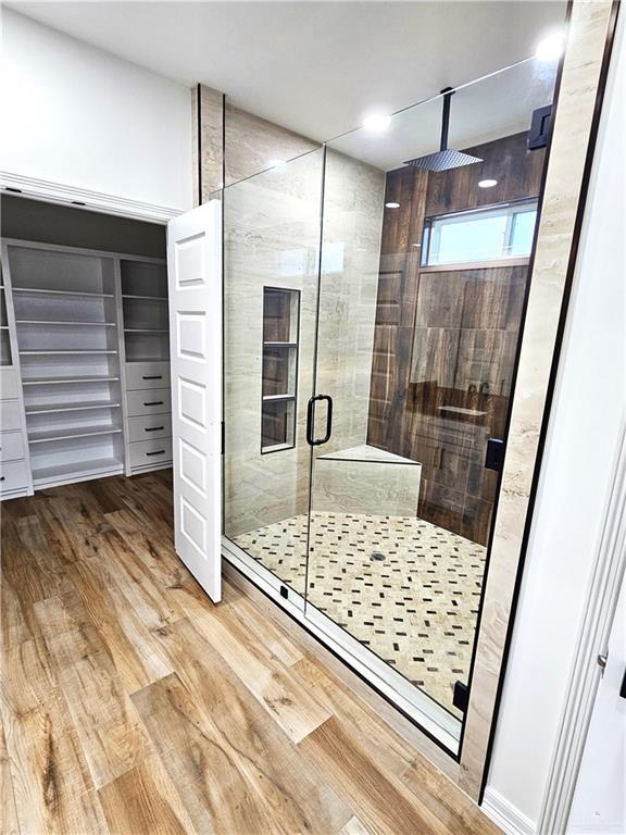 bathroom featuring hardwood / wood-style floors and an enclosed shower