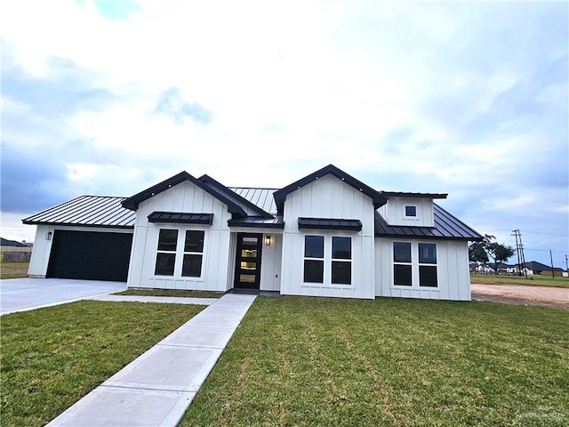 modern farmhouse with a front yard and a garage