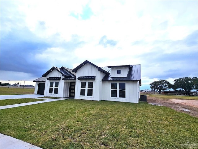 modern farmhouse with cooling unit and a front yard