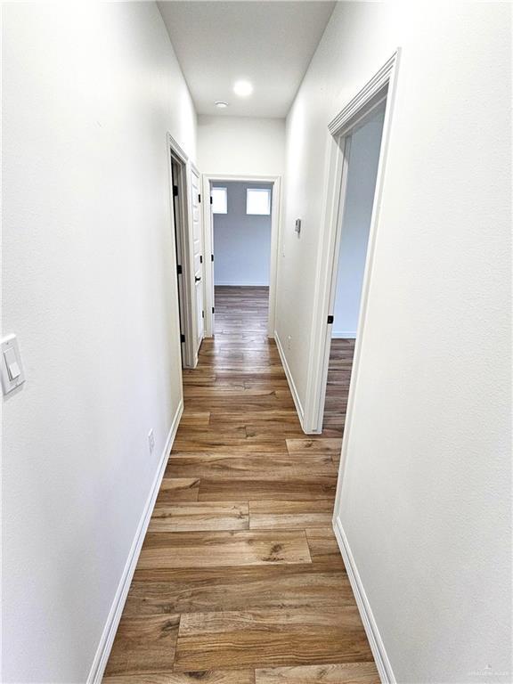 hallway with wood-type flooring