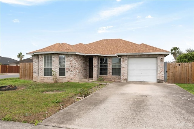 single story home with a garage, driveway, a front lawn, and roof with shingles