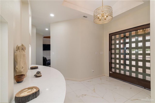 foyer entrance featuring a chandelier, marble finish flooring, recessed lighting, and baseboards