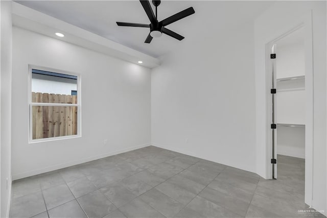 tiled empty room with ceiling fan