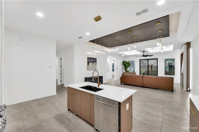 kitchen featuring pendant lighting, sink, a kitchen island with sink, stainless steel dishwasher, and ceiling fan