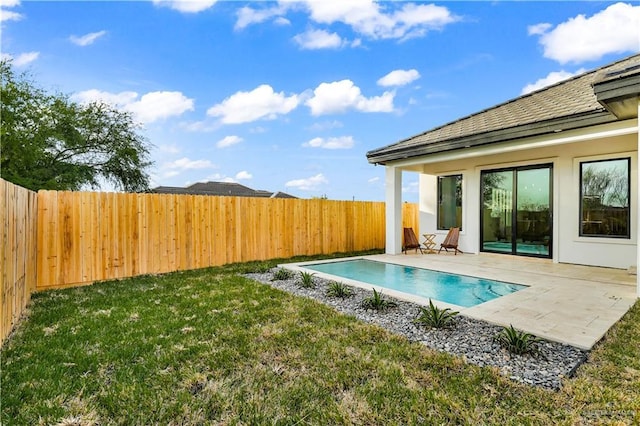 view of pool with a yard and a patio