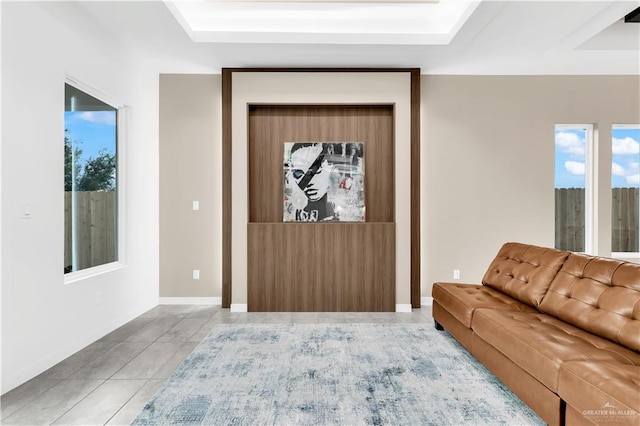 tiled living room with a raised ceiling