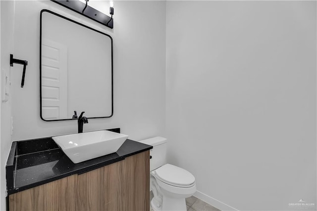 bathroom with vanity, tile patterned flooring, and toilet