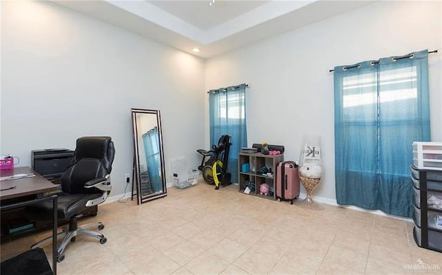 tiled office space with recessed lighting and baseboards