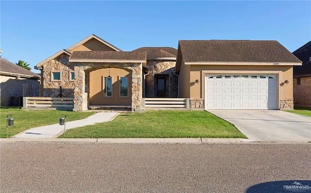 view of front of home with stucco siding, concrete driveway, an attached garage, stone siding, and a front lawn