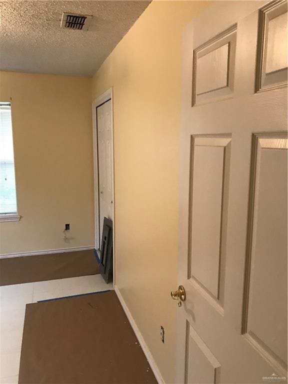 815 Pueblo St, Mission, TX 78572 - corridor with a textured ceiling and baseboards
