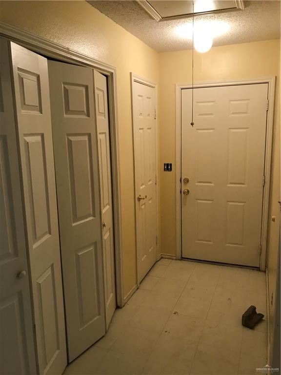 815 Pueblo St, Mission, TX 78572 - doorway to outside with a textured ceiling