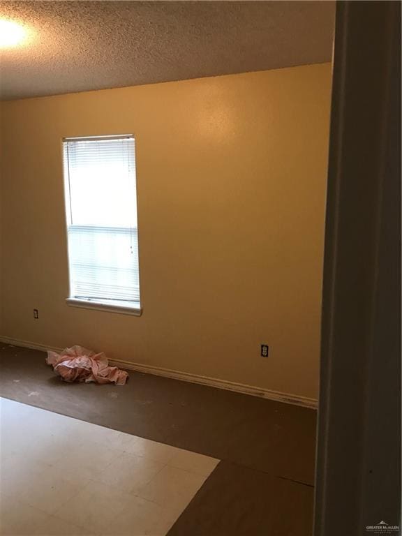 815 Pueblo St, Mission, TX 78572 - spare room featuring baseboards and a textured ceiling