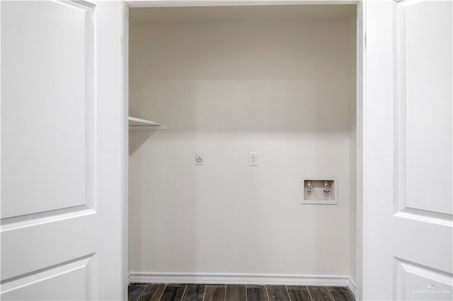 washroom featuring laundry area, hookup for a washing machine, dark wood-type flooring, and baseboards