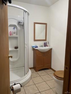 bathroom with tile patterned floors, vanity, toilet, and a shower with door