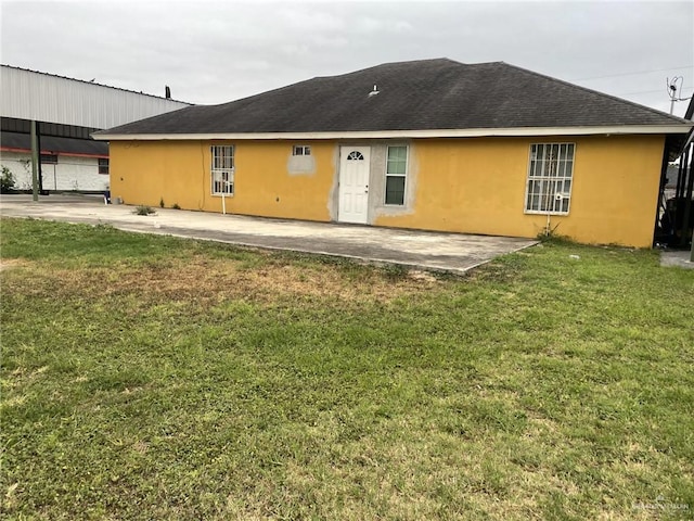 back of property featuring a yard and a carport