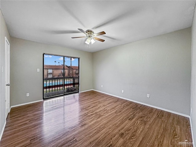 spare room with ceiling fan and wood-type flooring