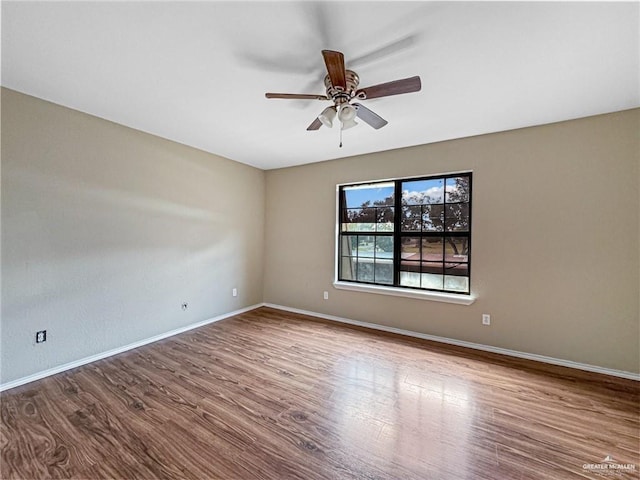 empty room with ceiling fan and hardwood / wood-style floors