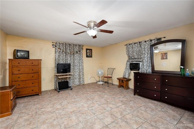 living room with ceiling fan and a fireplace