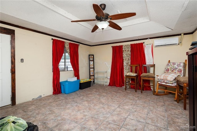 living area with ceiling fan, a raised ceiling, a textured ceiling, and a wall unit AC