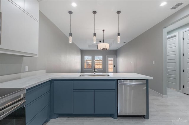 kitchen featuring blue cabinetry, sink, pendant lighting, stainless steel appliances, and white cabinets