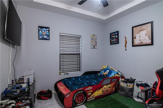 tiled bedroom featuring ceiling fan