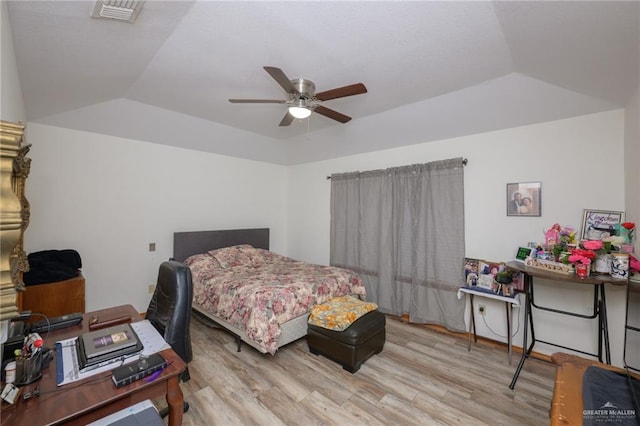 bedroom featuring light wood-type flooring, ceiling fan, and lofted ceiling