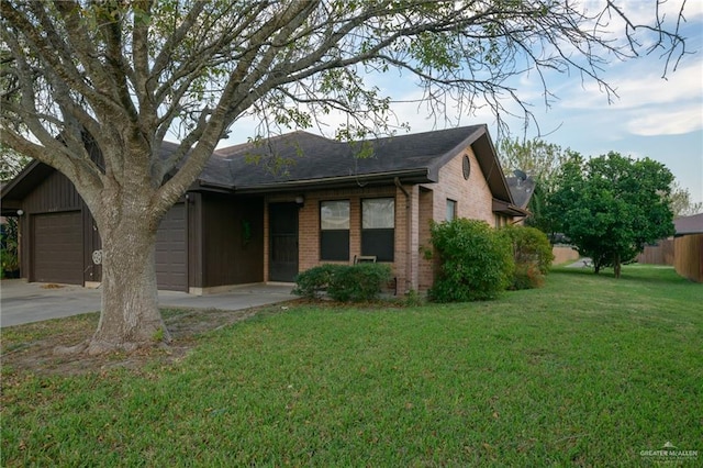 ranch-style house featuring a front yard and a garage