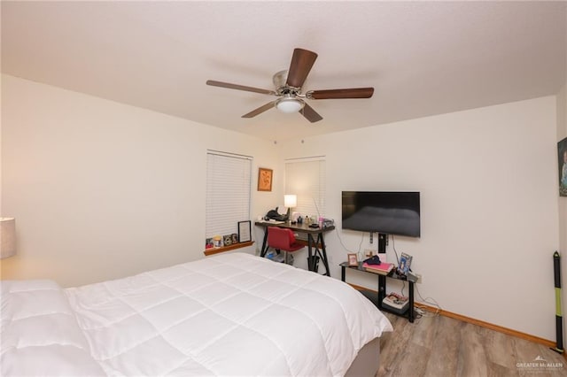 bedroom with light hardwood / wood-style flooring and ceiling fan