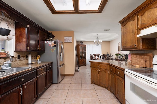 kitchen with light tile patterned floors, electric stove, stainless steel fridge with ice dispenser, backsplash, and a sink