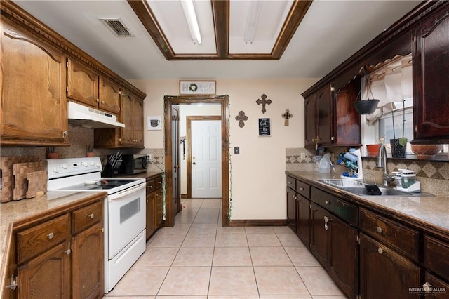 kitchen with under cabinet range hood, electric range, a sink, visible vents, and stainless steel microwave