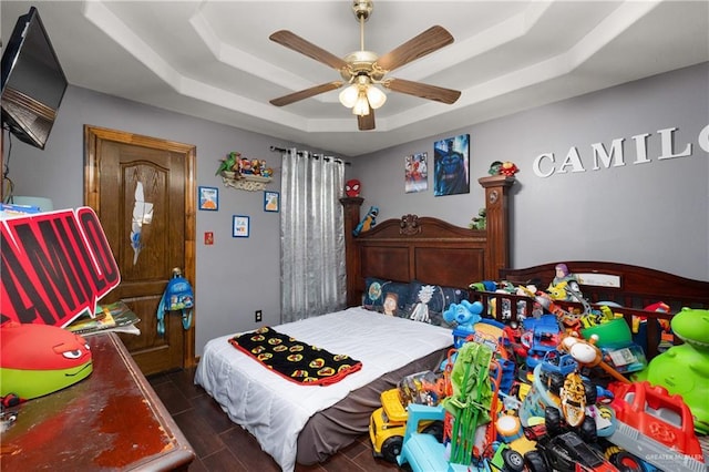 bedroom featuring a ceiling fan and a raised ceiling