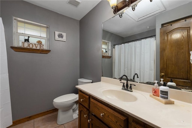 bathroom featuring visible vents, baseboards, toilet, tile patterned flooring, and vanity