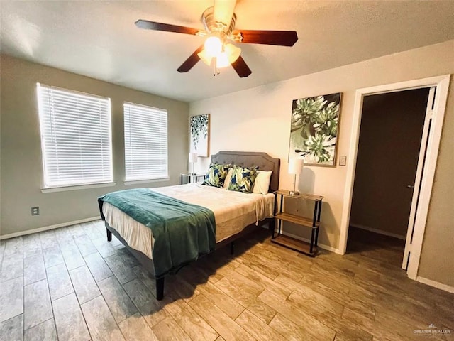 117B E Mezquite St, South Padre Island, TX 78597 - bedroom with light wood finished floors, baseboards, and ceiling fan