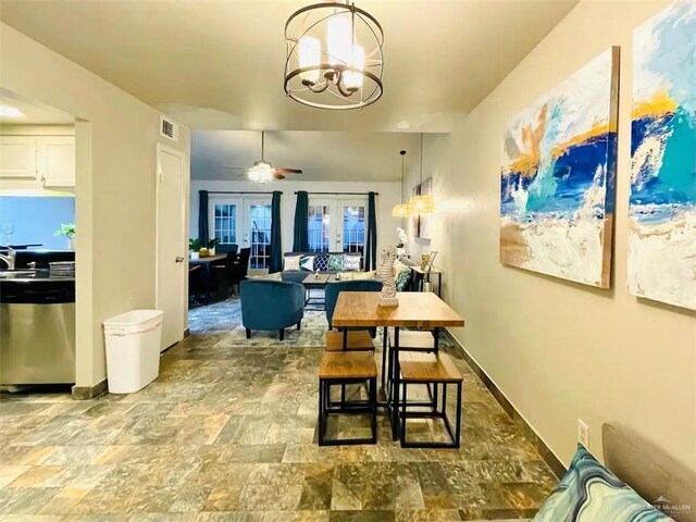 117B E Mezquite St, South Padre Island, TX 78597 - dining space with a chandelier, ceiling fan, stone finish floors, french doors, and baseboards