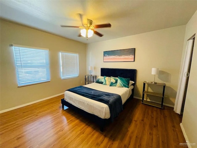 117B E Mezquite St, South Padre Island, TX 78597 - bedroom with wood finished floors, baseboards, and ceiling fan