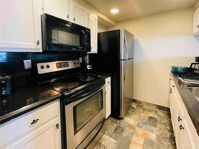117B E Mezquite St, South Padre Island, TX 78597 - kitchen with stainless steel appliances, white cabinets, baseboards, stone finish flooring, and recessed lighting