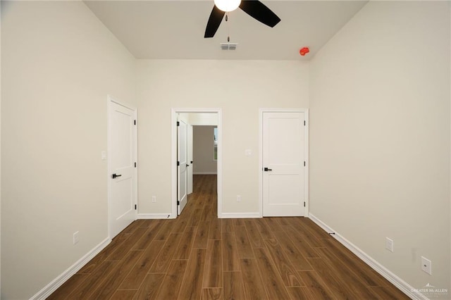 interior space with ceiling fan and dark wood-type flooring