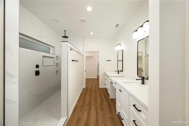 bathroom featuring a shower, vanity, and hardwood / wood-style flooring