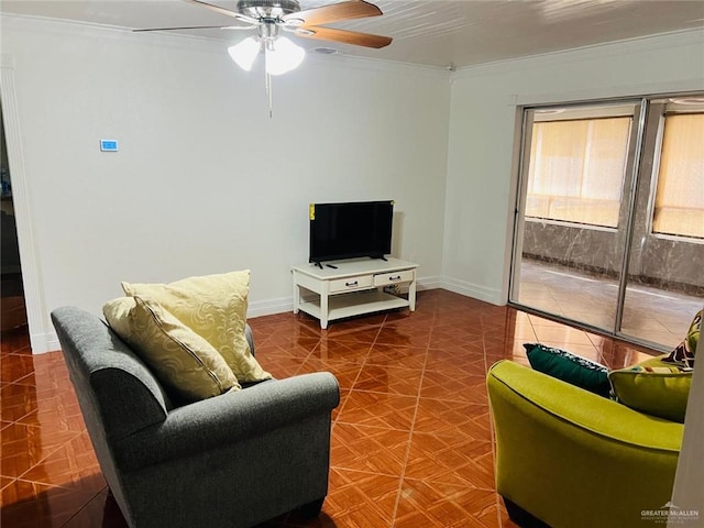 living room with crown molding and ceiling fan