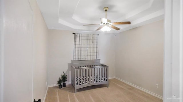 315 Oregano St, Edinburg, TX 78541 - bedroom featuring a raised ceiling, a crib, carpet, and ceiling fan