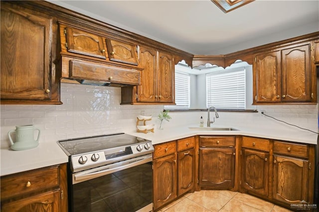 315 Oregano St, Edinburg, TX 78541 - kitchen featuring stainless steel range with electric cooktop, light tile patterned flooring, light countertops, and tasteful backsplash