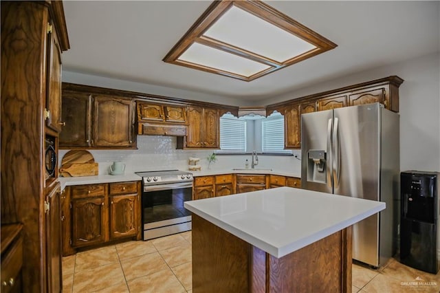 315 Oregano St, Edinburg, TX 78541 - kitchen with stainless steel appliances, under cabinet range hood, light tile patterned floors, light countertops, and backsplash