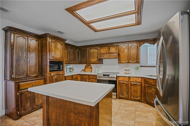 315 Oregano St, Edinburg, TX 78541 - kitchen with appliances with stainless steel finishes, light tile patterned floors, light countertops, and a center island