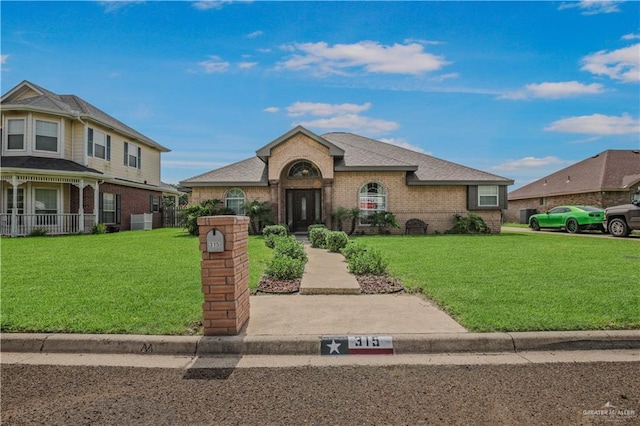 315 Oregano St, Edinburg, TX 78541 - view of front of property with brick siding and a front yard