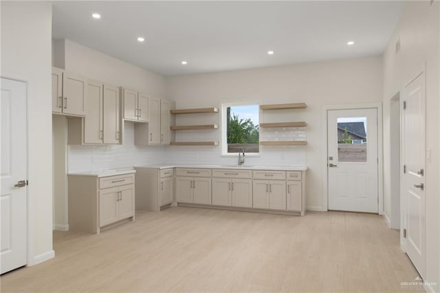 1202 N Lincoln Ave, San Juan, TX 78589 - kitchen with a sink, backsplash, light wood-style flooring, and recessed lighting